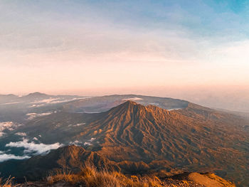 Aerial view of mountain range against cloudy sky