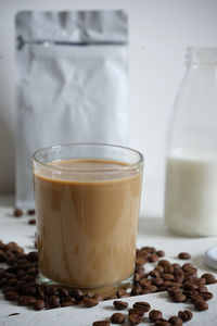 Close-up of coffee beans in glass on table