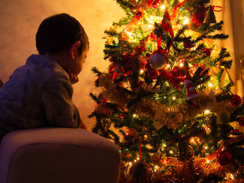 Man in illuminated christmas tree