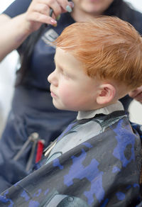 Redhead 4 year old boy in a barbershop