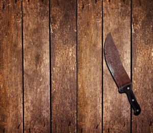 Directly above shot of rusty knife on hardwood floor