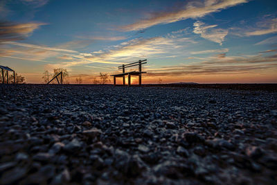 Surface level of sea against sky during sunset