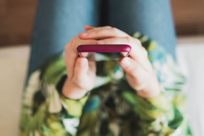 Midsection of man using mobile phone