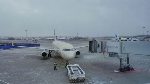 Airplane on runway against sky