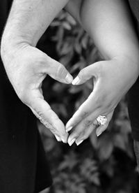 Cropped image of hands making heart shape