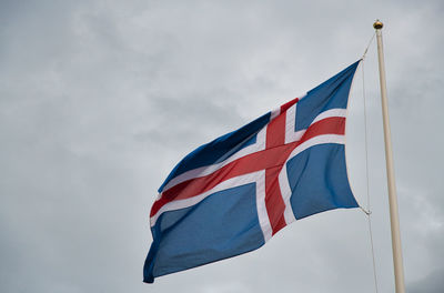 Low angle view of flag against sky