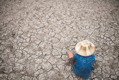 High angle view of girl holding dry leaf