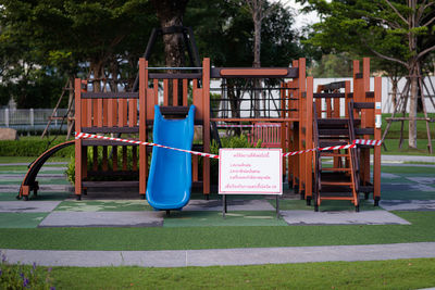 View of playground against trees in park