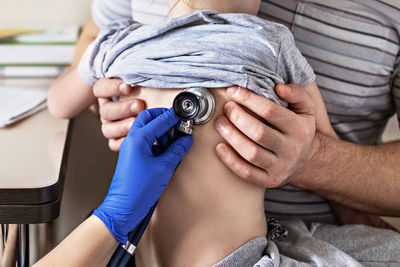 Little girl  in the doctor's office.the doctor listens to the lungs with a phonendoscope.