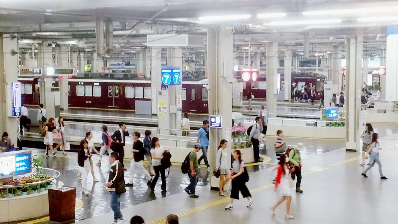 indoors, transportation, public transportation, architecture, built structure, mode of transport, railroad station, travel, person, large group of people, men, train - vehicle, rail transportation, incidental people, city life, text, railroad station platform, city, communication