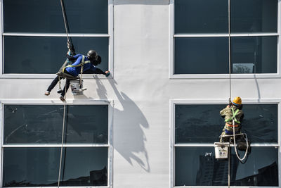 People working in glass building