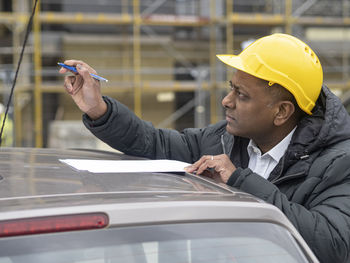 Side view of businessman using mobile phone