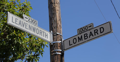 Low angle view of road sign against sky