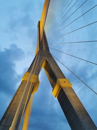 Low angle view of bridge against cloudy sky