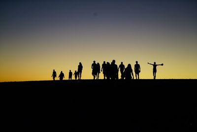 Silhouette of woman against clear sky at sunset