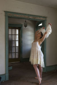 Full length of woman standing in abandoned building