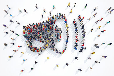 High angle view of group of people over white background