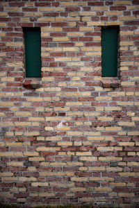 Low angle view of window on brick wall