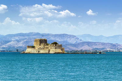 Building by sea against sky