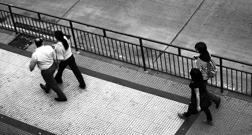 Full length of woman standing by railing