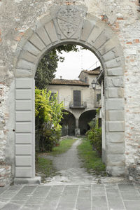 Archway leading towards arch in garden