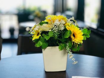 Close-up of yellow flower vase on table