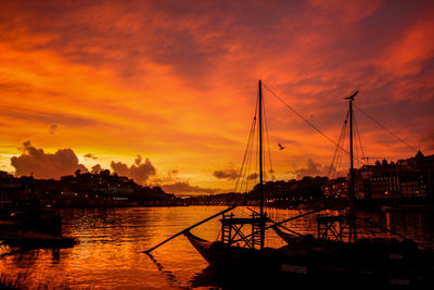 Boats moored in sea during sunset