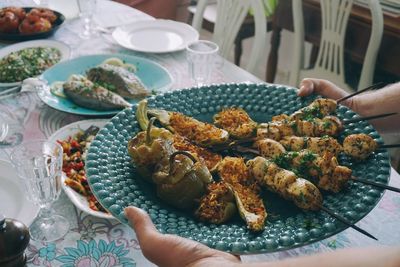 High angle view of person preparing food in plate on table