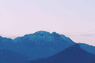 Scenic view of mountains against blue sky