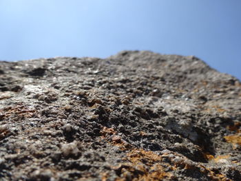 Close-up of rocks on mountain against clear sky