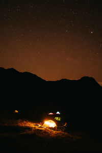 Scenic view of mountains against sky at night