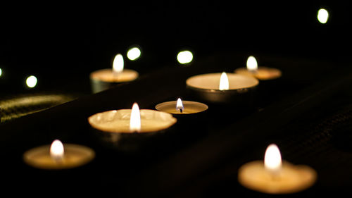 Close-up of illuminated tea light candles