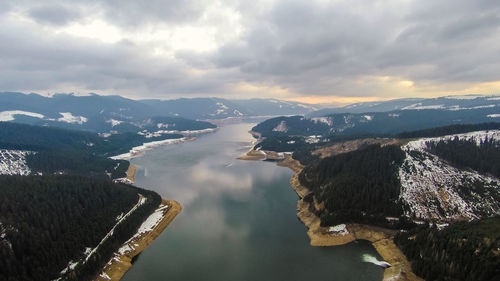 High angle view of sea and mountains against sky