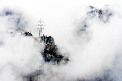 View of communications tower against cloudy sky