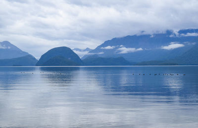 Scenic view of lake and mountains against sky