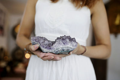 Midsection of woman holding crystal