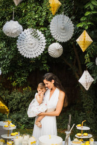 Beautiful young woman with flowers and plants