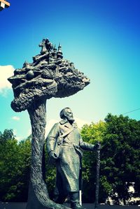 Low angle view of statue against clear blue sky