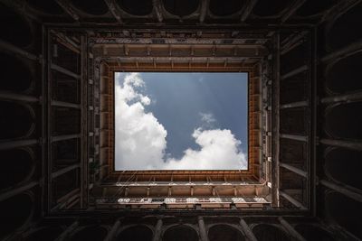 Directly below shot historic building against cloudy sky