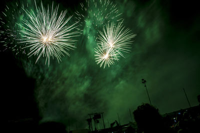 Low angle view of firework display at night