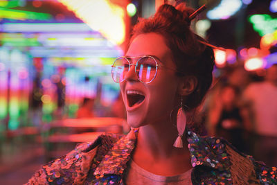 Portrait of young woman shouting at bar