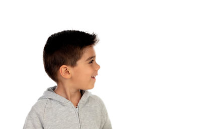 Portrait of boy standing against white background