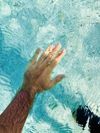 Close-up of hand swimming in pool