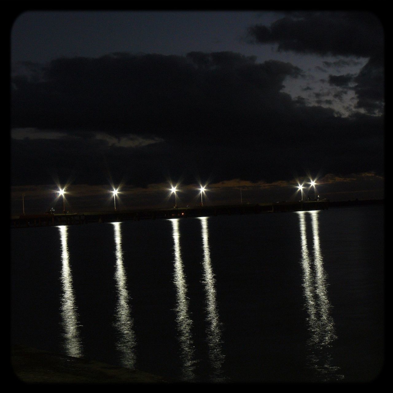 water, transfer print, sky, sea, reflection, auto post production filter, tranquil scene, scenics, waterfront, tranquility, beauty in nature, night, illuminated, cloud - sky, nature, silhouette, horizon over water, idyllic, dusk, cloud