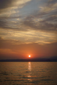 Scenic view of sea against romantic sky at sunset