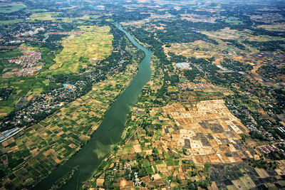 High angle view of the agricultural rice fields and the jeneberang river that divides the building