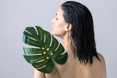 Close-up of young woman against white background