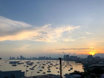 High angle view of buildings against cloudy sky during sunset