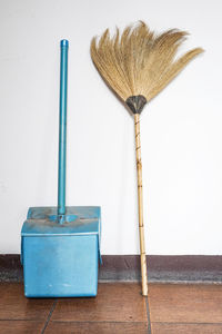 Broom and dustpan against wall at home