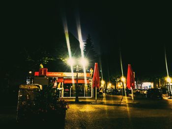 Illuminated lights against sky at night